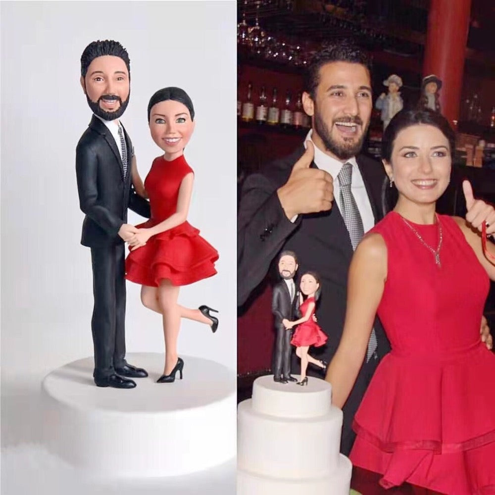 Couple posing with custom couple bobbleheads from photo, a personalized anniversary gift and cake topper keepsake