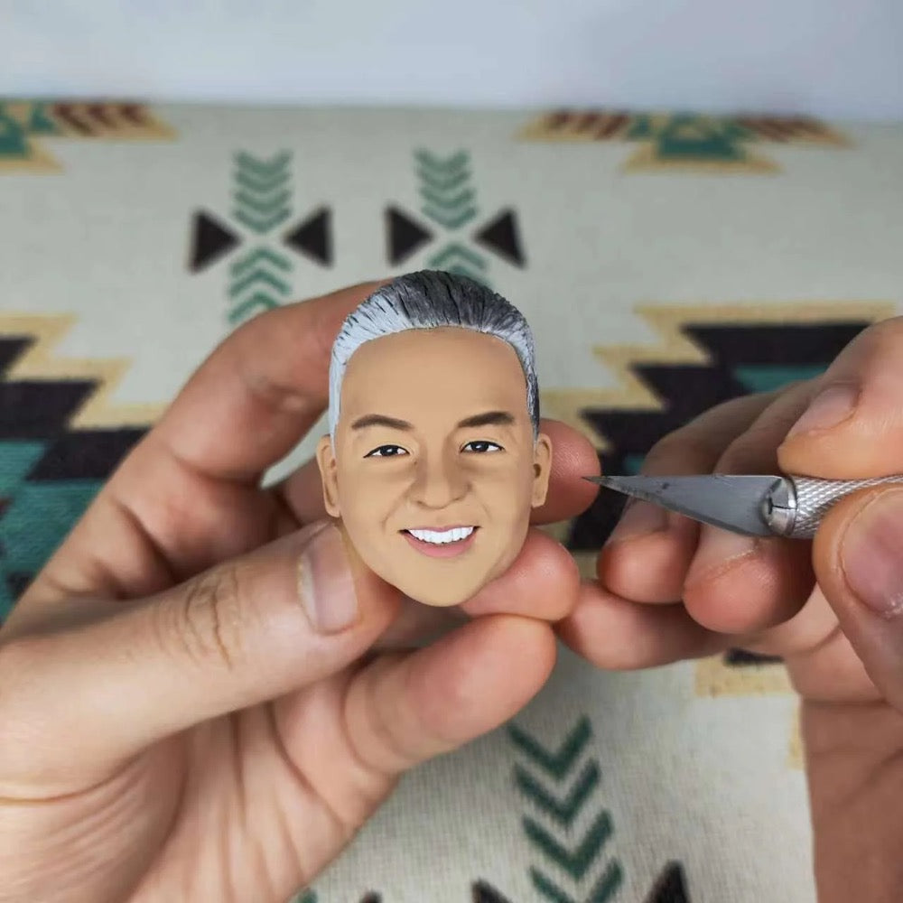 Handcrafted custom chef bobblehead being painted with a smiling face, showcasing personalized details for a unique gift.