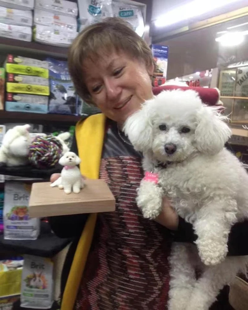 Woman holding a small white dog in a store setting with pet products in the background