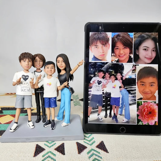 Customized family figurines next to a tablet displaying photos of a family.